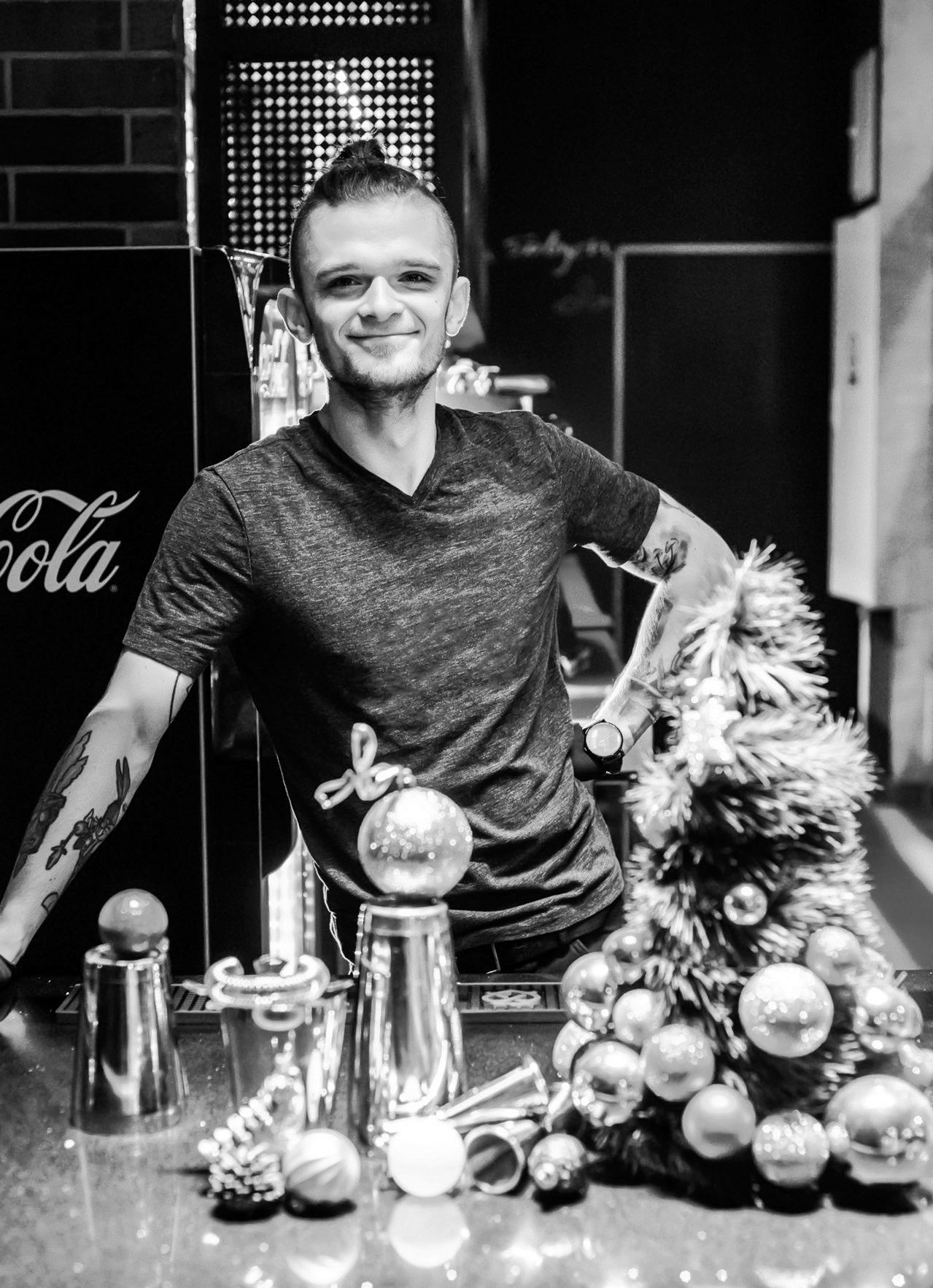Uśmiechnięty barman przy świątecznym barze w Hadesie, zdjęcie czarno-białe